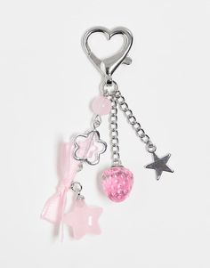 a pink heart charm with charms attached to it's sides and a star on the side