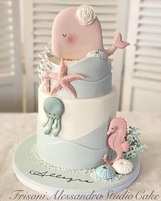 a three tiered cake decorated with sea animals