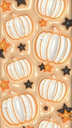 an image of pumpkins and stars in the air on a sheet of foiled paper