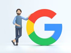 a man standing next to the google logo with his hand on the top of it