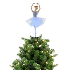 a ballerina is standing on top of a christmas tree