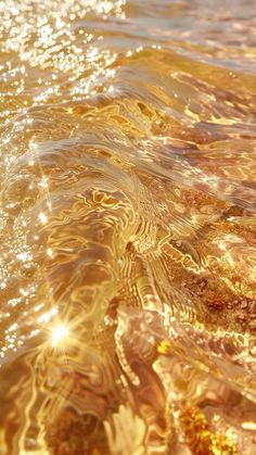 the sun shines brightly on the water and it's golden reflections are visible