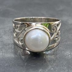 Solid 925 sterling silver fresh water Pearl ring with filigree design band, handmade and fair trade Natural Pearl Weight - Dimensions - L x B x H cm L x B x H inch Ring size - U.K. - U.S. - E.U. - Band width - Post - royalmail recorded Silver Sterling Pearl Ring, White Sterling Silver Hallmarked Pearl Ring, White Pearl Promise Ring Stamped 925, Hallmarked White Pearl Ring In Sterling Silver, White Hallmarked Sterling Silver Pearl Ring, Elegant White Engraved Ring Stamped 925, Silver Pearl Promise Ring Stamped 925, Hallmarked Sterling Silver Pearl Ring, Silver Sterling Silver Pearl Ring