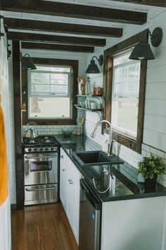 the kitchen is clean and ready to be used as a dining area in this tiny home