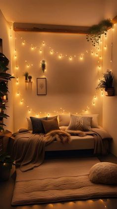 a bed with lights on the wall above it and plants in pots hanging from the ceiling