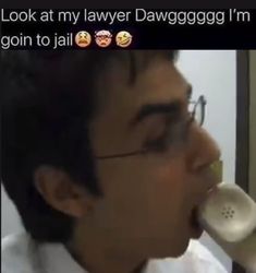 a man with glasses is holding an old phone up to his mouth and has the caption look at my lawer dawgggogg i'm going to jail