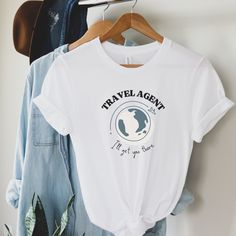 World Travel Advisor Tshirt perfect for all the travel agents at your travel agency! Your travel agents coordinate, plan, and pull off incredible vacations for you and your loved ones. Don't forget to thank them with this cute, trendy, retro travel agent t-shirt. Or if you are a travel agent yourself and want to show off what your are best at, gift this to yourself! Wear it on your next vacation!  Other variations of this style available at Draft Designs Studio. Check it out! This classic unisex Travel Agency Gift Ideas, White Graphic Print T-shirt For Travel, White Crew Neck T-shirt For Travel, Short Sleeve Tops With Letter Print For Travel, White Graphic Print Top For Travel, Cotton Short Sleeve T-shirt For Travel, White Cotton Top For Travel, White Letter Print Top For Travel, Cotton Crew Neck T-shirt For Travel