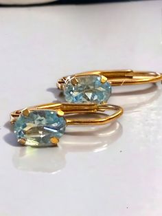 BEAUTIFUL Vintage 10k Yellow Gold Oval Blue Topaz Lever Back Earrings! * Gorgeous pierced earrings in solid 10k yellow Gold, each earring has an oval Blue topaz stone! * In beautiful pre-loved condition! * Weigh .8 grams * Very Pretty, would make a great gift! Ships FAST and FREE, fully insured and in a gift box. I guarantee item to be as described and pictured so please shop with confidence : ) Gold Oval Blue Topaz Earrings, Oval Gold Topaz Earrings, Seed Pearl Ring, Gold Apple, Blue Topaz Stone, Black Gift Boxes, Topaz Stone, Pierced Earrings, Pearl Ring