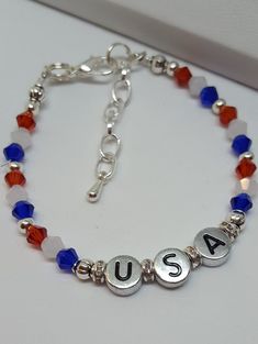 "USA Bracelet This darling USA bracelet is fun conversation jewelry and would make perfect festival jewelry. Trendy Jewelry is both fun jewelry and makes great gifts for her. Holiday bracelets help make the day special and this piece is a sweet reminder that Americana gifts are great way to show American Pride. Bracelet is 6 1/2\" with a 1 1/2\" extension. The stamped silver colored beads are double sided. This listing is for the Bracelet ONLY Hypoallergenic to eliminate irritation/ Excellent cu Fun Letter Beads Jewelry For Birthday Gift, Cute Sterling Silver Bracelets For Gift, Cute Sterling Silver Bracelets For Gifts, Fun Letter Beads Jewelry Birthday Gift, Cute Silver Friendship Bracelets As Gift, Adjustable Fun Style Bracelet Jewelry, Nickel Free Charm Bracelet For Birthday Gift, Nickel Free Charm Bracelet For Friendship, Nickel Free Name Bracelet For Friendship And Mother's Day