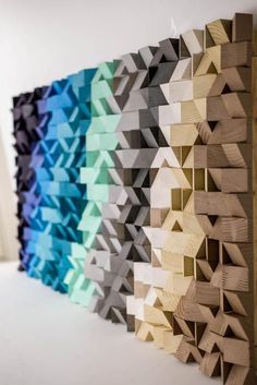 several different colors of wood are arranged on the wall