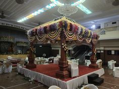 an elaborately decorated stage in a banquet hall