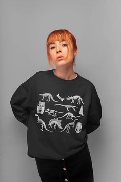 Dinosaur Sweatshirt Skeletons Sweater Goblincore Clothing Aesthetic Clothing Dark Academia Pullover Dino Sweatshirt Dino Crewneck Sweater. Sweatshirt features: *Made from 50% cotton, 50% polyester (heathers colors are 40% cotton, 60% polyester) *Medium-heavy fabric (8.0 oz/yd² (271.25 g/m *Loose fit *Oversized if you choose 1-2 sizes bigger *Sewn-in label *Runs true to size *Crewneck *Unisex style *Ribbed knit collar *Without itchy side seams Canvas Tote Bag features (available in black color): Casual Dinosaur Print Tops For Fall, Long Sleeve Top With Dinosaur Print For Fall, Cotton Tops With Dinosaur Print For Fall, Cotton Top With Dinosaur Print For Fall, Casual Dinosaur Print Crew Neck Sweatshirt, Winter Dinosaur Print Crew Neck Top, Black Dinosaur Print Crew Neck Top, Clothing Dark Academia, Dinosaur Sweatshirt