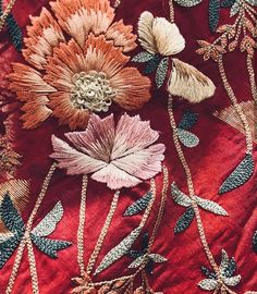 closeup of an embroidered fabric with flowers on it