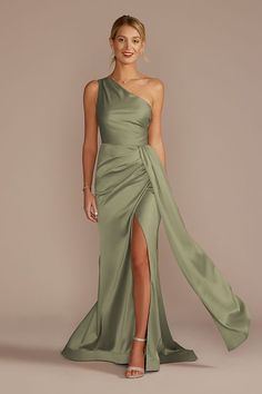 a woman in a long green dress with one slit on the side and an asymmetric