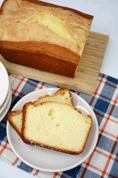 two slices of bread on a plate next to a loaf of bread