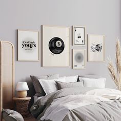 a bedroom with grey walls and pictures on the wall