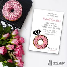 a donut and flowers on a table next to a card