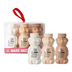 three baby bottles in the shape of bears with a red ribbon hanging from it's top