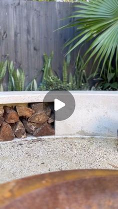 an outdoor fire pit with logs in it