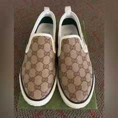 Size: 8 1/2 Gucci Tennis 1977 Beige Canvas Slip-On Sneakers Designer Beige Sneakers With Rubber Sole, Luxury Beige Round Toe Sneakers, Gucci Beige Low-top Sneakers, Luxury Gucci Beige Sneakers, Luxury Beige Gucci Sneakers, Gucci Low-top Cream Sneakers, Gucci Cream Low-top Sneakers, Gucci Casual Cream Sneakers, Beige Slip-on Sneakers With Leather Sole