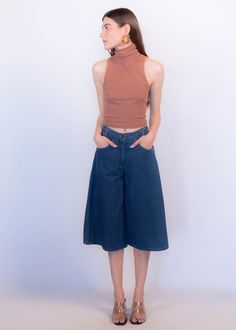 "Vintage 70s boho denim culottes. These great culottes are trending this season and are just perfect for summer style! High-waist fit. X criss-cross belt loops. Front pockets. Back western yoke detail. Wide-leg silhouette. Front button and zipper fastening. Unlined. Cut from 100% cotton. We kindly ask that you please view all measurements for comparison so you can get your desired fit. * Brand: n/a * Decade: 1970s * Fabric: 100% Cotton * Lining: Unlined * Color: Medium Dark Wash C O N D I T I O Versatile High Waist Flare Jeans For Spring, High Waist Cotton Culottes For Spring, 70s Inspired Wide Leg Jeans For Spring, Cotton Wide-leg Cropped Jeans For Summer, Summer Wide-leg Cropped Cotton Jeans, Retro Wide Leg Jeans For Summer, Versatile High Rise Summer Flare Jeans, Versatile High-rise Flare Jeans For Summer, 70s Inspired Denim Jeans For Spring