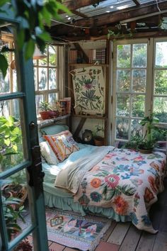 a bed sitting inside of a bedroom next to a window filled with potted plants