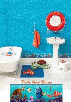 a bathroom with blue walls and flooring has fish on the rugs next to the sink