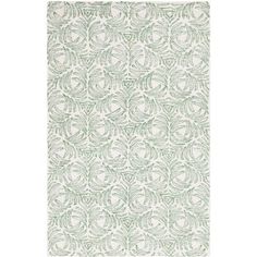 a green and white rug with an intricate design on the bottom, in front of a white background