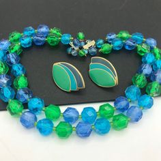 254.00 USD Vintage blue green, beaded high end, jewelry set, 1950's 1960's jewelry, mid century jewelry, beaded jewelry set, collectible necklace earring set Very nice colorful jewelry set in very good vintage condition. The necklace measures 17 1/2 inches long and the earrings are 1 1/2 x 1 inch. A very nice-looking married set and a great addition to any outfit or jewelry collection. #vintage #blue #green #multistrand #2strand #necklace #earrings #jewelryset d4 1970 Vintage Minnie Mouse Green Clothing Necklace, Retro Jewelry With Faceted Beads, Retro Blue Beaded Jewelry, Blue Beaded Retro Jewelry, Vintage Turquoise Jewelry With Colorful Beads, Vintage Green Jewelry With Faceted Beads, Blue Mid-century Jewelry For Formal Occasions, Mid-century Blue Formal Jewelry, Mid-century Green Formal Jewelry