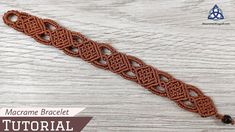 the macrame bracelet is shown on a wooden surface