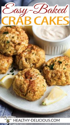 crab cakes on a white plate with lemon wedges and mayonnaise in the background