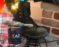 a pair of boots sitting next to a christmas tree