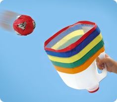 a person is flying through the air with a colorful object in it's hand