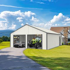 two tractors are parked in front of a garage on the side of a country road