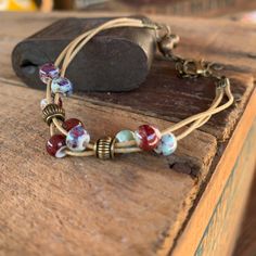 Whimsical & Vibrant Glazed Ceramic Beads On A Waxed String Cord. Antiqued Adjustable Chain Clasp, Bells + Beads Create A Rustic, Vintage Vibe. Handmade W/Natural Fibers. Hippie, Bohemian, Ethnic & Earthy. Festival, Beach Style With A Gypsy, Wanderlust Feel. Wear Layered Or Alone As Bracelet/Anklet. Sold Separately Or 3/$30 (See Other Listings) Red-Blue 6”-8”In. Flowers Pottery Jewelry Free People Beach Positive Vibes Festive Nature Rope Beads Charm Friendship Woven Surfer Retro Lucky Tribal Adjustable Czech Glass Beaded Bracelets For Festival, Adjustable Bracelets With Dangling Round Beads, Adjustable Beaded Bracelet With Dangling Beads For Gifts, Adjustable Beaded Bracelets With Dangling Beads, Adjustable Bracelet With Dangling Beads, Bohemian Czech Glass Jewelry For Everyday, Adjustable Hippie Jewelry With Round Beads, Bohemian Beaded Bracelets With Dangling Beads As Gift, Adjustable Multicolor Bracelets With Dangling Beads