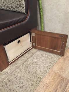 a close up of a drawer on the floor next to a bed frame and mattress