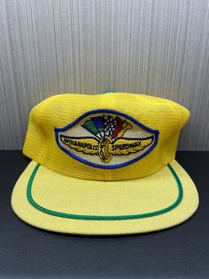 1970's Indianapolis Speedway Hat Retro Baseball Cap With Curved Brim, Vintage Wide Brim Adjustable Baseball Cap, Vintage Adjustable Wide Brim Baseball Cap, Retro Yellow Trucker Hat With Curved Brim, Retro Yellow Curved Brim Trucker Hat, Vintage Yellow Snapback Trucker Hat, Retro Yellow Baseball Cap, Vintage Yellow Snapback Baseball Cap, Vintage Yellow Adjustable Hat