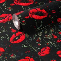 red flowers on black background with silver foil in the center and an open roll of tape