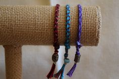 "These are handmade with multi-colored embroidery threads and glass, metal, acrylic and/or ceramic beads. The standard length is 8\". They are easy to put on and easy to take off. They look great worn alone but look fantastic if you put a combination of bracelets together. These handwoven bracelets are one of a kind and make a perfect gift for someone special. They are unisex and stylish for any age. You can special order any color combination (up to 5 colors) and length. Suggested Lengths: Male Adjustable Handwoven Braided Bracelets, Adjustable Woven Braided Bracelet With Round Beads, Adjustable Braided Bracelet With Round Beads, Bohemian Woven Braided Bracelets, Bohemian Purple Braided Friendship Bracelets, Purple Bohemian Braided Friendship Bracelets, Bohemian Purple Braided Friendship Bracelet, Purple Bohemian Braided Friendship Bracelet, Handmade Adjustable Thread Beaded Bracelets