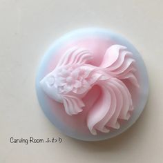 a close up of a pink and white object on a table with the words carving room 3 - 3 - 4