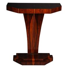 an art deco console table with black marble and wood inlays on the top