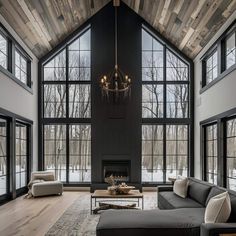 a large living room with high ceilings and windows