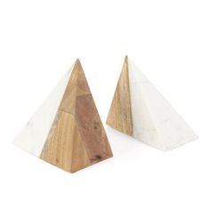 two white marble and wood pyramids sitting side by side on a white background,