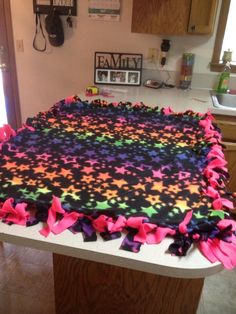 a colorful blanket on top of a counter in a kitchen