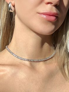 This elegant tennis necklace is crafted from 925 solid sterling silver and is studded with sparkling 4mm round-cut created diamonds for a total carat weight of 24.00-45.00TCW. The perfect accessory for any formal occasion, this necklace is both sophisticated and exclusive. This exquisite necklace has high polished rhodium finish that gives it a stunning shiny look that lasts for many years.Our created diamonds and gemstones are synthetic simulants (NOT natural/lab-grown/moissanite) that feature brighter D color , FL/VVS1 clarity and ideal cut making them visually indistinguishable from natural diamonds that cost thousands of dollars, but they don't pass the diamond test. We only use high quality solid gold/silver in our jewelry, WE DO NOT sell fake gold/silver jewelry. Every item, is shipp Gold Silver Jewelry, Moissanite Jewelry, Tennis Necklace, Chain Anklet, Huggie Hoop Earrings, Ring Bracelet, Formal Occasion, Lab Grown, Anklets