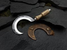 Our hand-forged sickle is a beautifully crafted tool that combines tradition and functionality, designed for easy use by anyone, regardless of skill level. Whether you're harvesting herbs, grains, or garden crops, this sickle offers a smooth and efficient cutting experience. Its versatility and ease of use make it a perfect gift for garden enthusiasts, farmers, or anyone who appreciates practical, high-quality tools. Materials and Craftsmanship: Blade: ✓ 52100 Steel: The blade is expertly hand-f Harvesting Herbs, Ash Tree, Light Coat, Gardening Tools, Linseed Oil, Leather Sheath, Ergonomic Handle, Ash Wood, Traditional Techniques