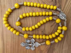 "Rosary handmade in Medjugorje by our family, using yellow wooden prayer beads, Pardon Crucifix pendant with Immaculate Heart of Mary centerpiece medal. Medals and crucifix made in Italy.  Choose your cord color in dropdown menu. Message card of Holy Lady from Medjugorje included.Also a free Medjugorje powers card with every multi item order. NOTE: We also have Custom Gift Cards, all You need to do after purchase is to send us message via \"note to seller\" with text You would like to write on G Traditional Yellow Necklace With 8mm Beads, Yellow Spiritual Rosary As Gift, Yellow Gold Rosary With Miraculous Medal As Gift, Spiritual Rosary With Miraculous Medal And Crucifix, Adjustable Rosary With Miraculous Medal Gift, Spiritual Yellow Wooden Beads, Spiritual Yellow Gold Rosary With Round Beads, Divine Mercy Chaplet Rosary, Yellow 8mm Bohemian Beads