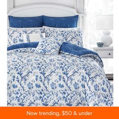 a bed with blue and white comforters in a bedroom