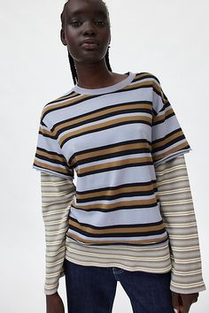 Better-than-basic BDG long sleeve tee in a pre-layered style. Designed in a relaxed, slouchy fit featuring crew neckline & short sleeve tee, with waffle-knit layered long-sleeves and hemline for an effortless vibe. Only at Urban Outfitters. Features BDG Ollie layered twofer tee Layered long sleeve tee Soft and stretchy knit Crew neckline and short sleeves with layered waffle-knit long sleeves Waffle-knit layered hemline Oversized, relaxed fit Tunic length Easy pull-over style UO exclusive Conten Fall Season Layering T-shirt, Fall Layering Crew Neck T-shirt, Spring Layering T-shirt, Spring T-shirt For Layering, Trendy Crew Neck Top For Layering, Oversized T-shirt For Spring Layering, Spring Oversized T-shirt For Layering, Casual Layered Tops For Spring, Spring Layering T-shirt With Shirttail Hem