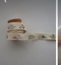 two images one showing a roll of fabric and the other shows a rolled up ribbon with flowers on it